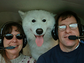 Linda, Lightning, and Paul in the cockpit of the Piper Tri-Pacer